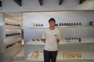 Clayton, standing in front an assortment of luxury products