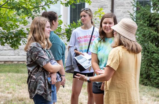 Dr. Nicole Monnier, Associate Chair of SLLC, talking to a group of students outside