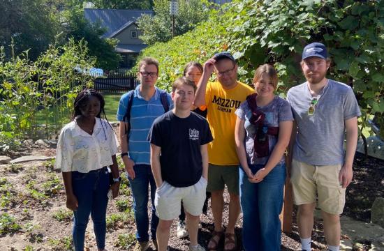 Students standing in vineyard smiling